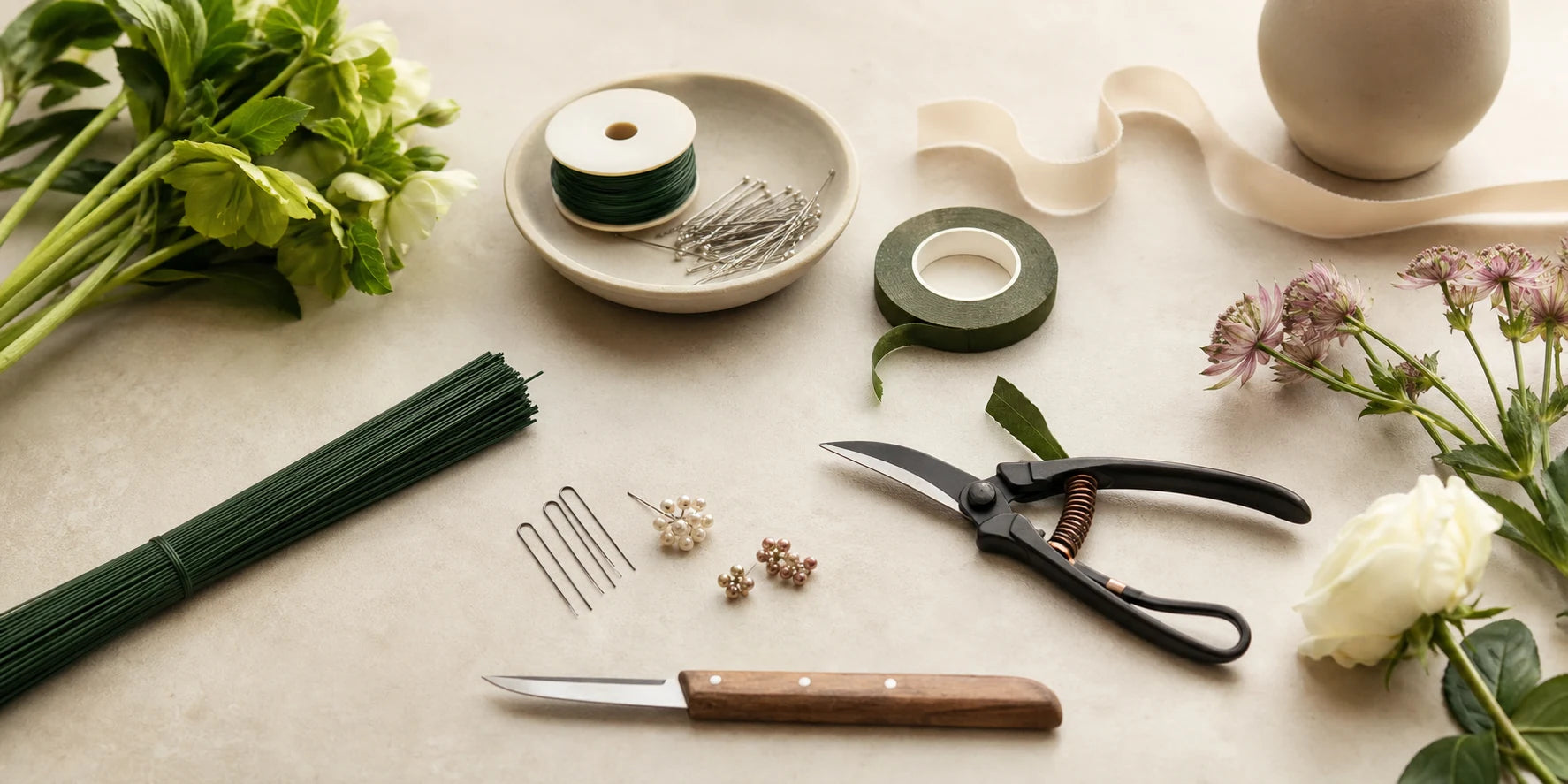 Organized florist tools floral tape wire and accessories on a clean workspace