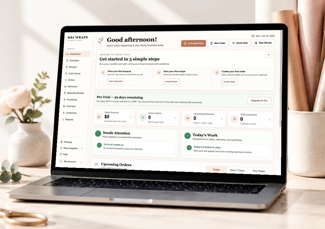 Real BBJ WRAPS Florist Manager Dashboard on a laptop in a minimal florist workspace